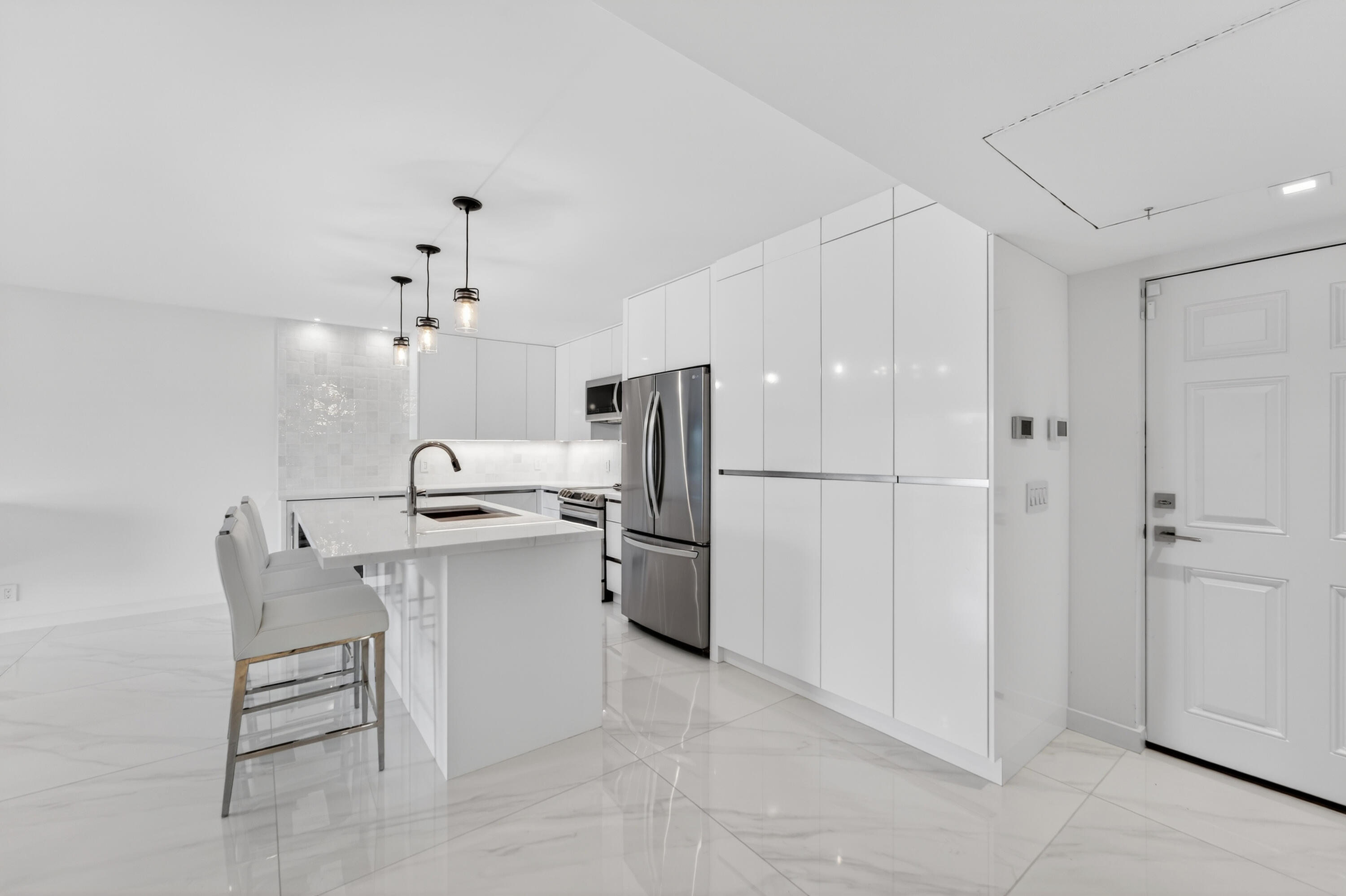 725 Hummingbird Way, Unit 103 North Palm Beach, FL 33408 - Photo 31 of 52 a kitchen with a sink and refrigerator