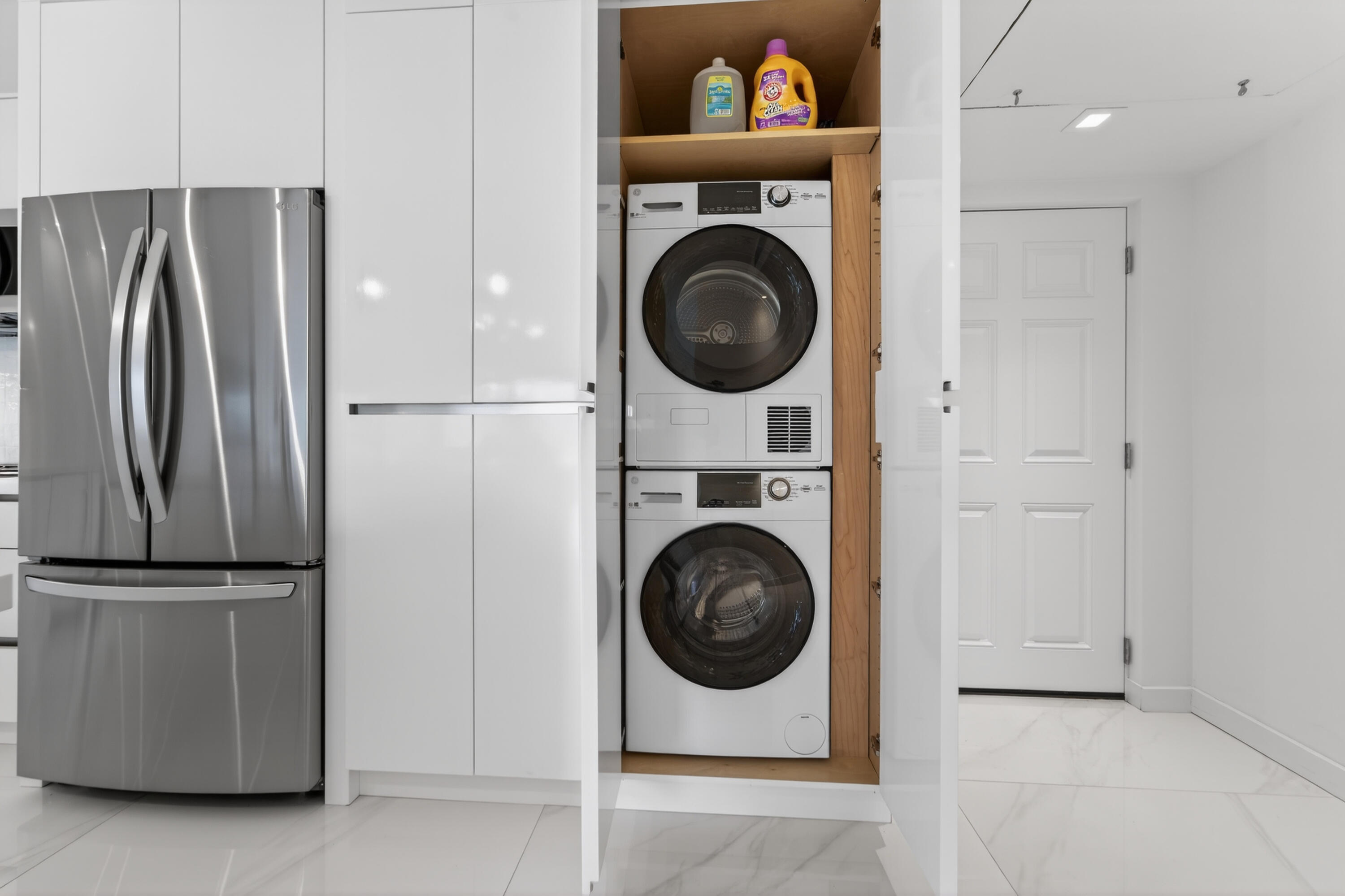 725 Hummingbird Way, Unit 103 North Palm Beach, FL 33408 - Photo 33 of 52 a view of a refrigerator and washer in a kitchen