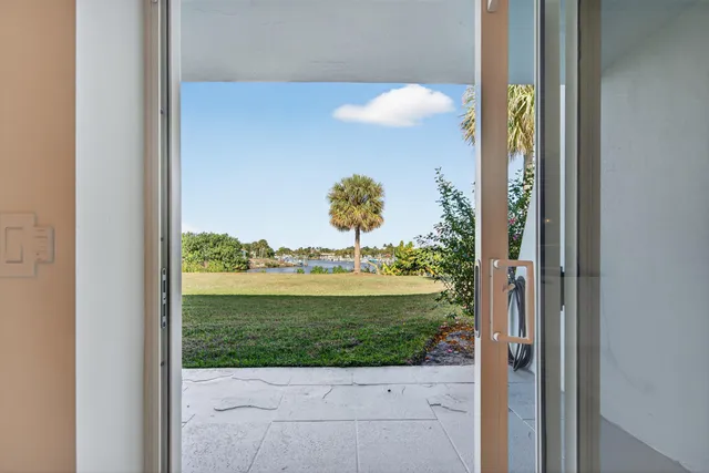 a view of a house with a yard and sitting area