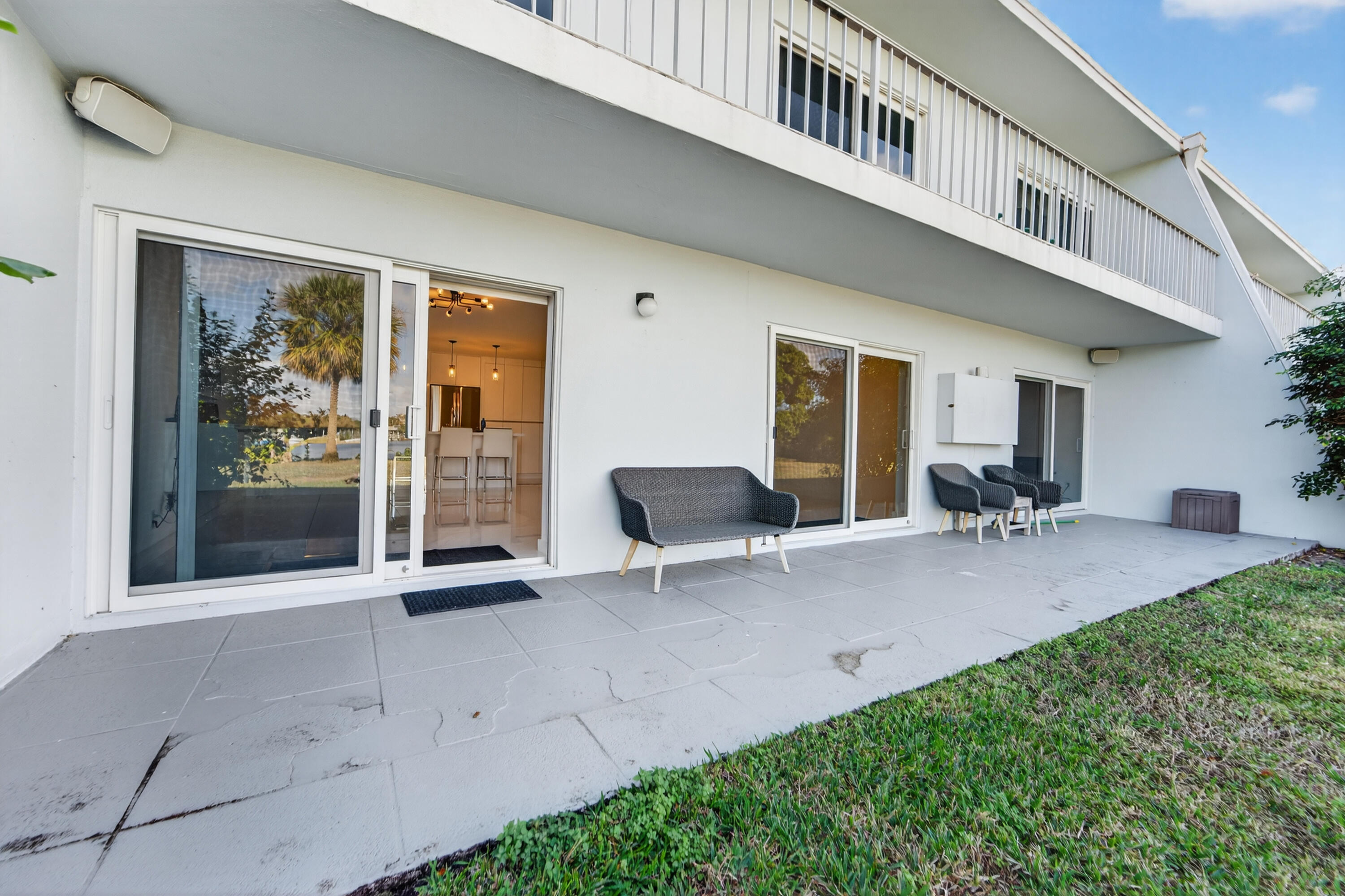 725 Hummingbird Way, Unit 103 North Palm Beach, FL 33408 - Photo 36 of 52 a view of a house with backyard and sitting area