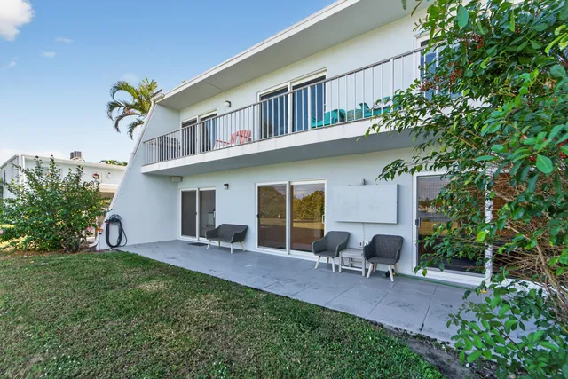 a view of a lake with couches in front of house