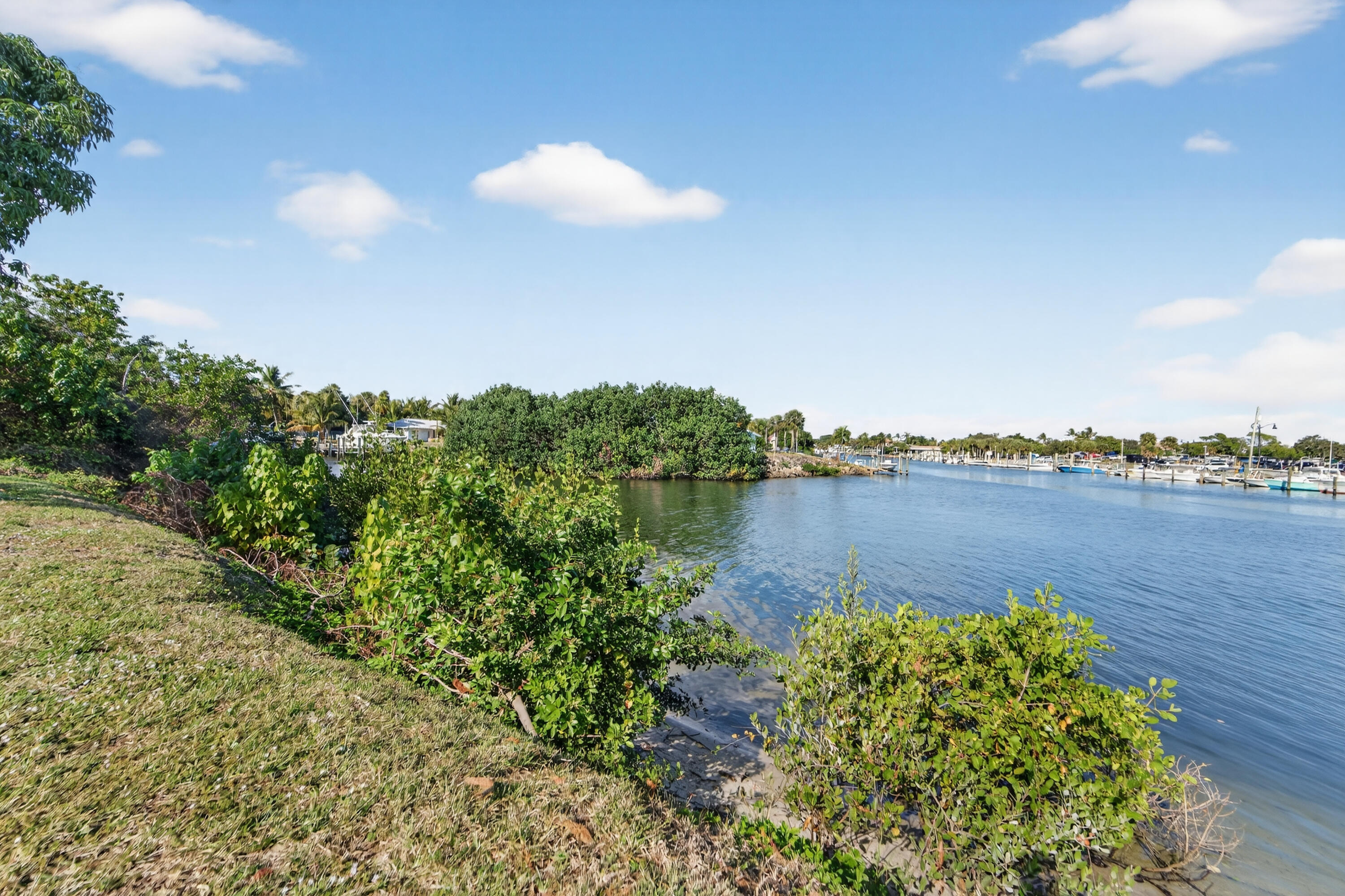 725 Hummingbird Way, Unit 103 North Palm Beach, FL 33408 - Photo 40 of 52 a view of a lake with a city