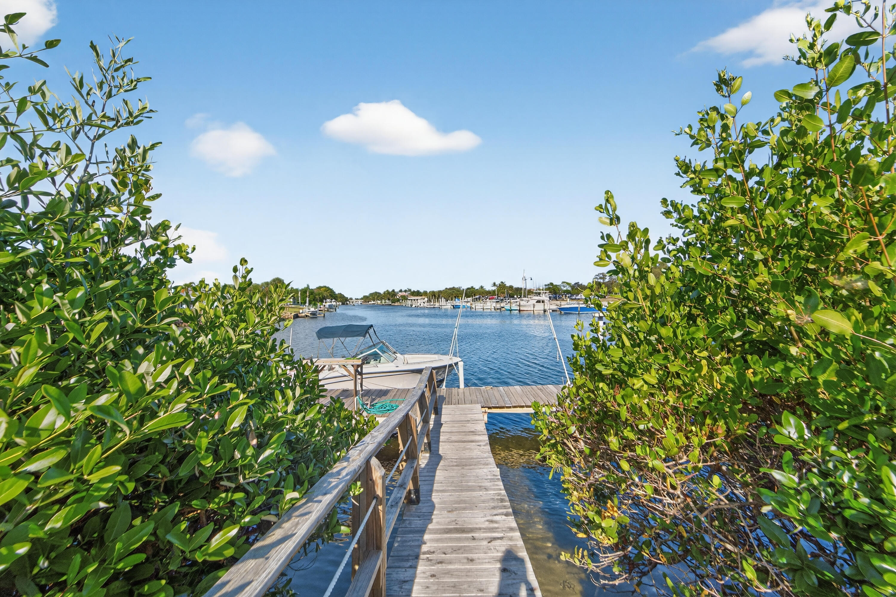 725 Hummingbird Way, Unit 103 North Palm Beach, FL 33408 - Photo 41 of 52 a view of a balcony with wooden fence