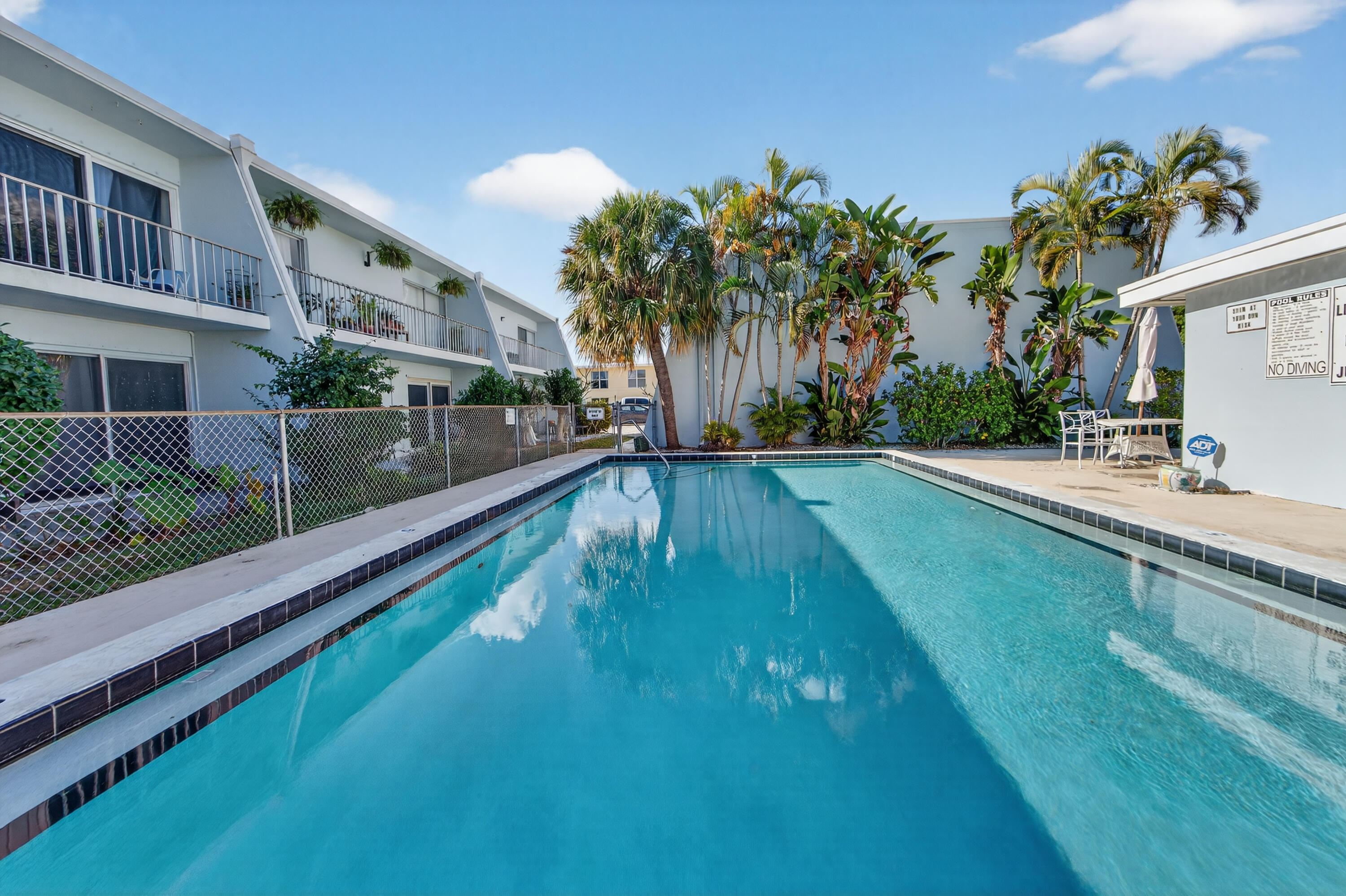 725 Hummingbird Way, Unit 103 North Palm Beach, FL 33408 - Photo 46 of 52 a view of swimming pool with a yard