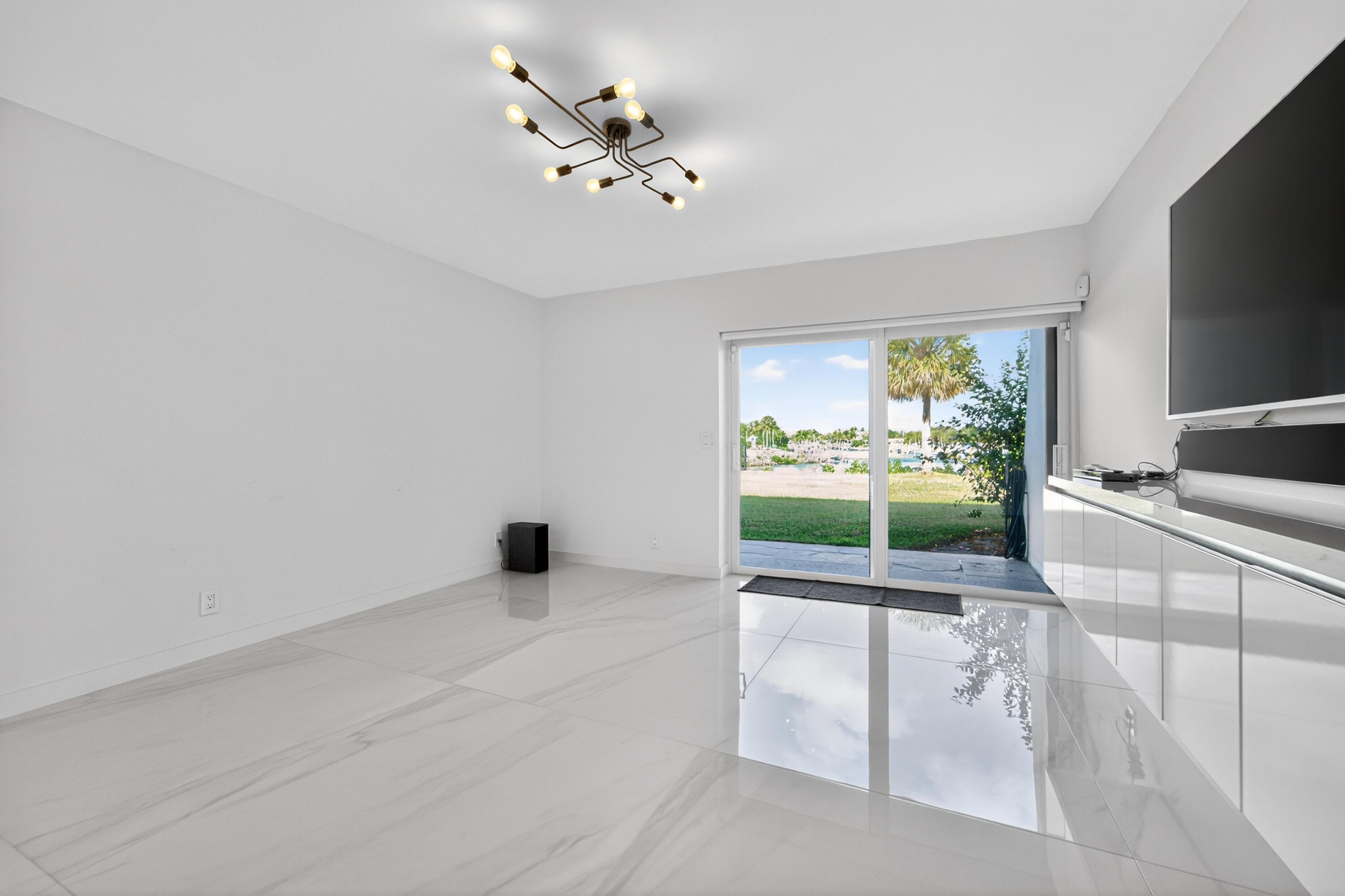 725 Hummingbird Way, Unit 103 North Palm Beach, FL 33408 - Photo 6 of 52 a view of an empty room with a window