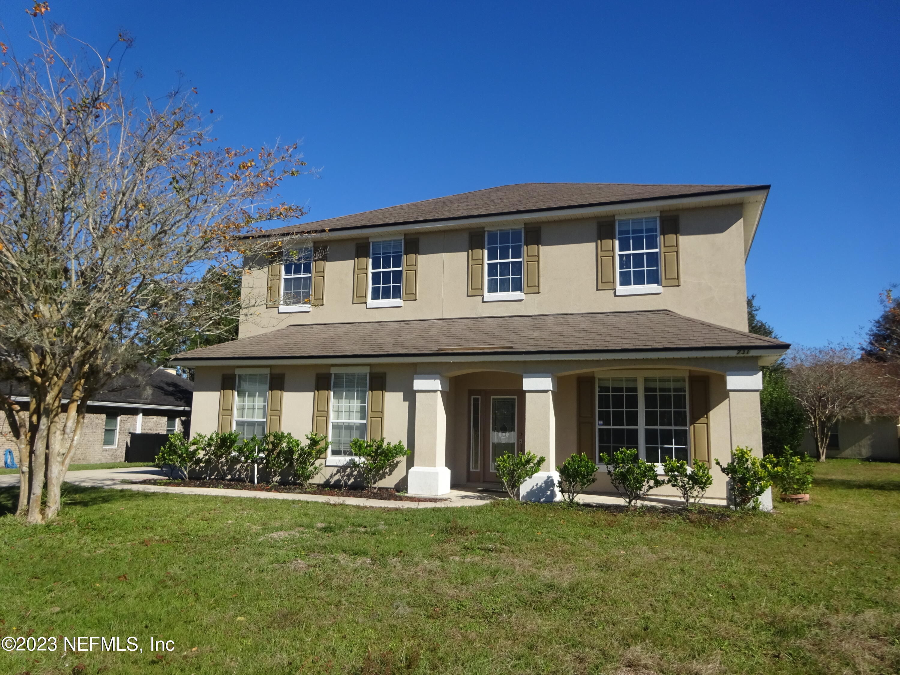 a front view of a house with a garden and porch