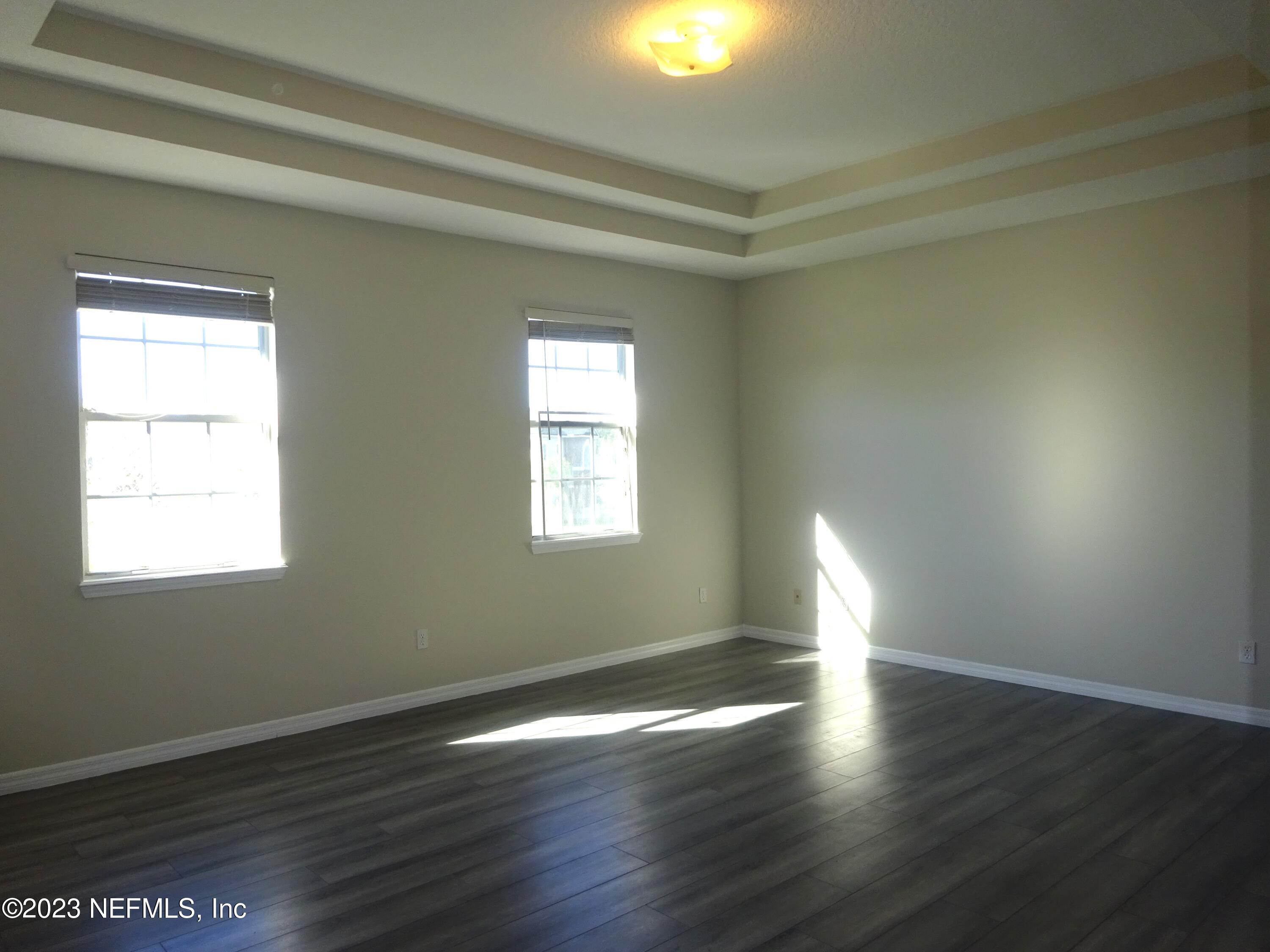 731 East Red House Branch Road St. Augustine, FL 32084 - Photo 17 of 54 an empty room with wooden floor and windows