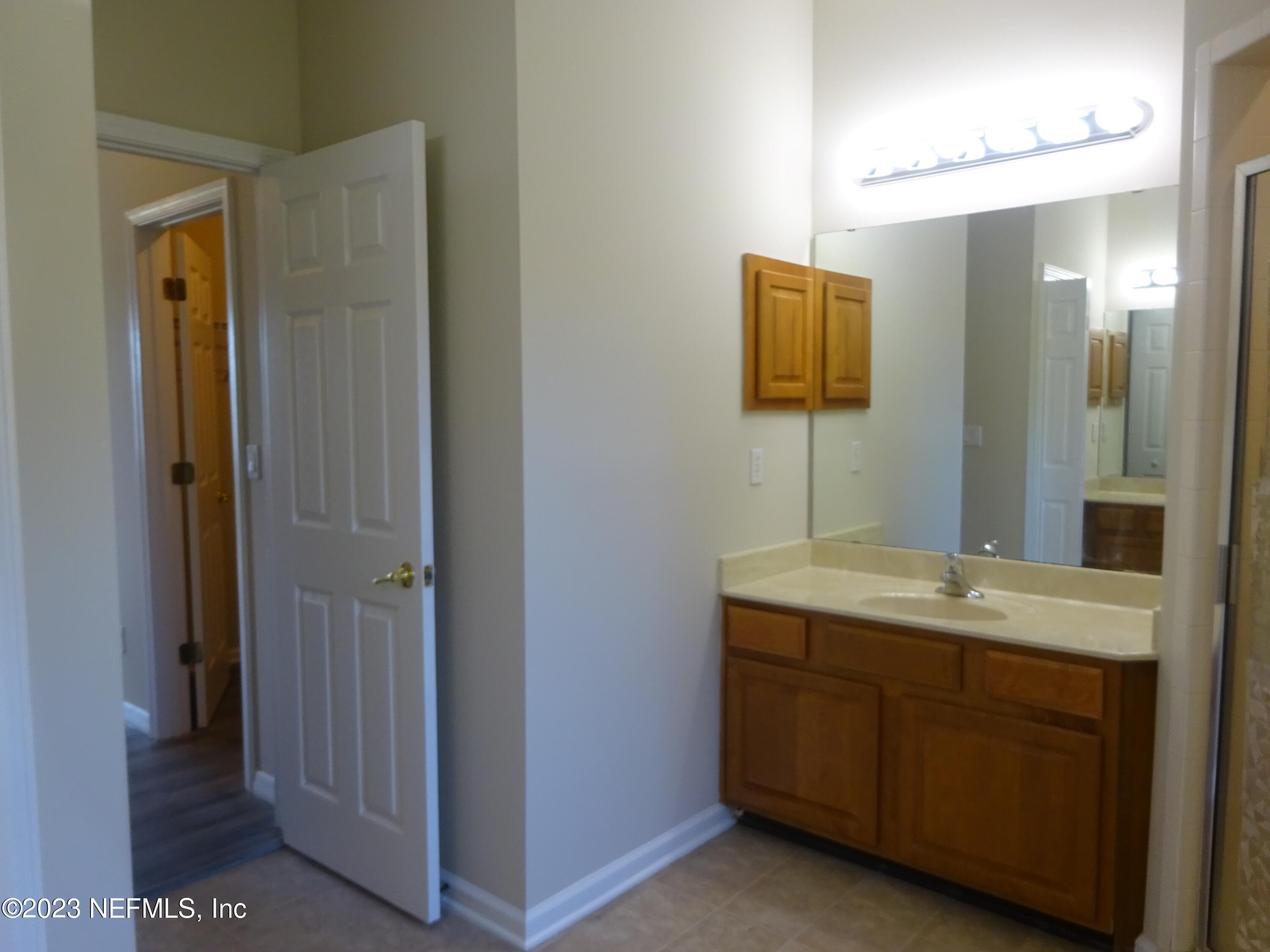 731 East Red House Branch Road St. Augustine, FL 32084 - Photo 21 of 54 a bathroom with a granite countertop sink a mirror and a vanity