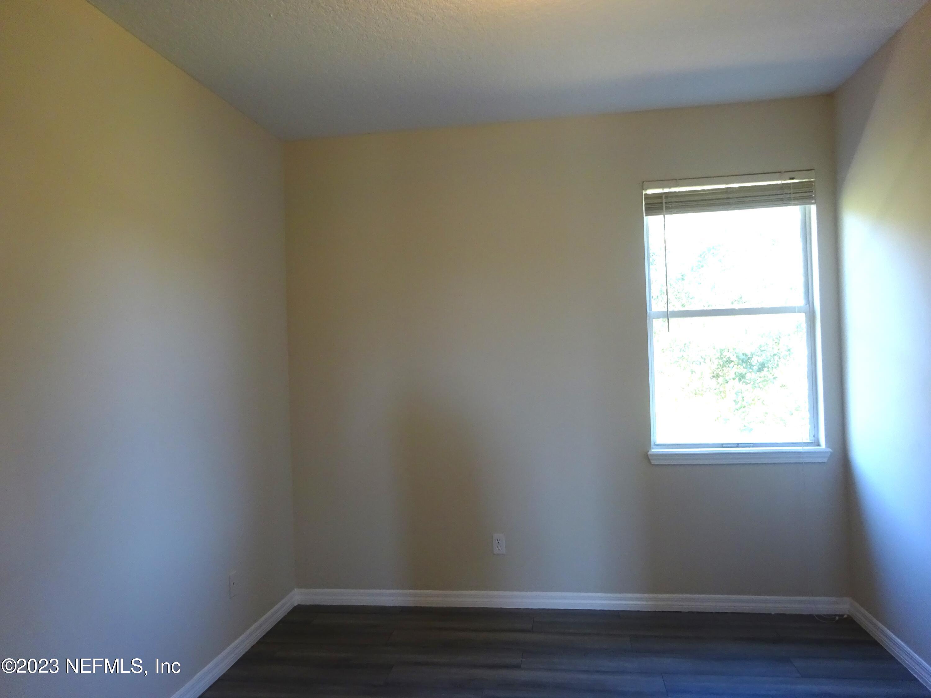 731 East Red House Branch Road St. Augustine, FL 32084 - Photo 24 of 54 a view of an empty room with wooden floor and a window