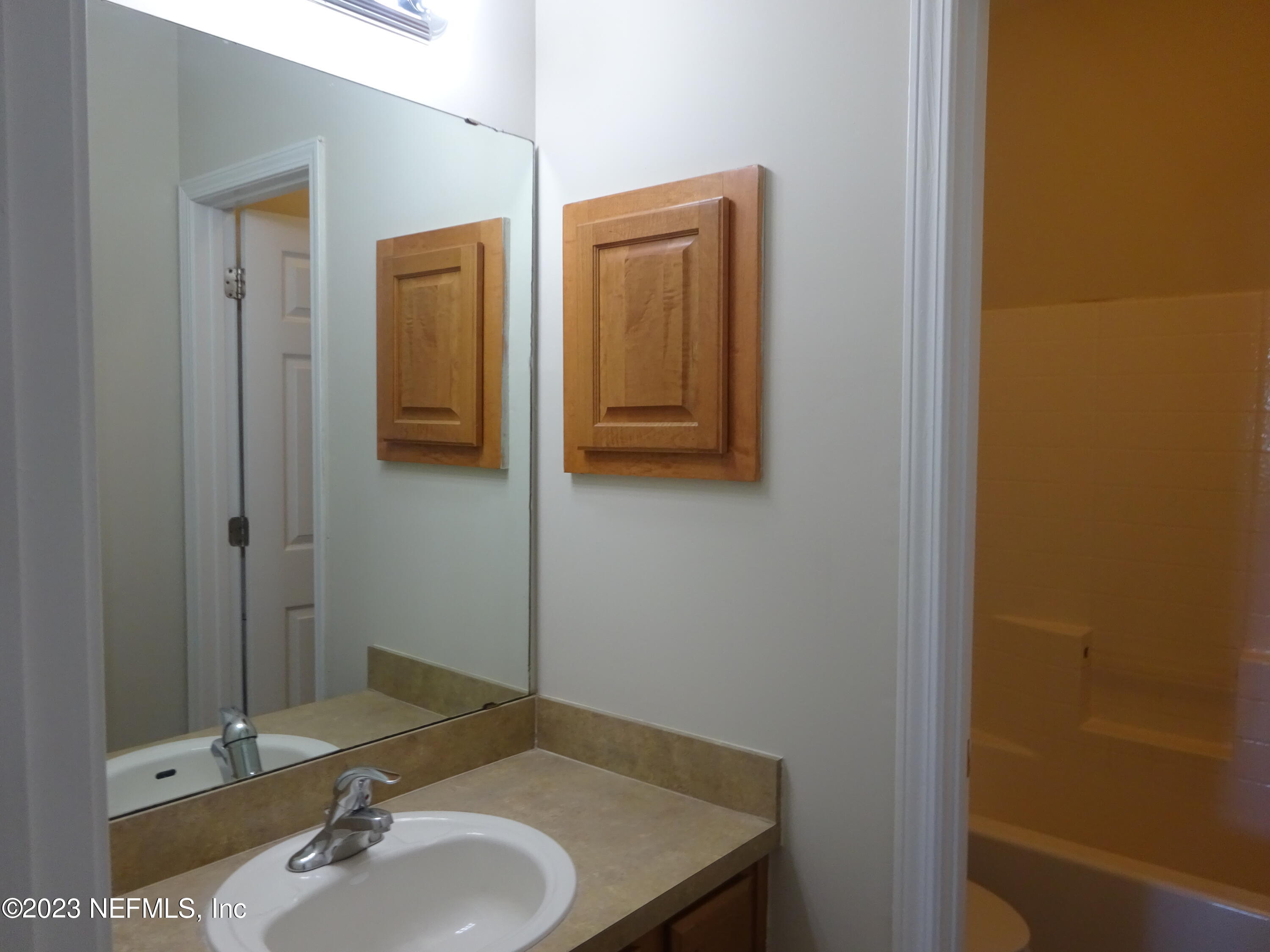 731 East Red House Branch Road St. Augustine, FL 32084 - Photo 26 of 54 a bathroom with a sink and a mirror