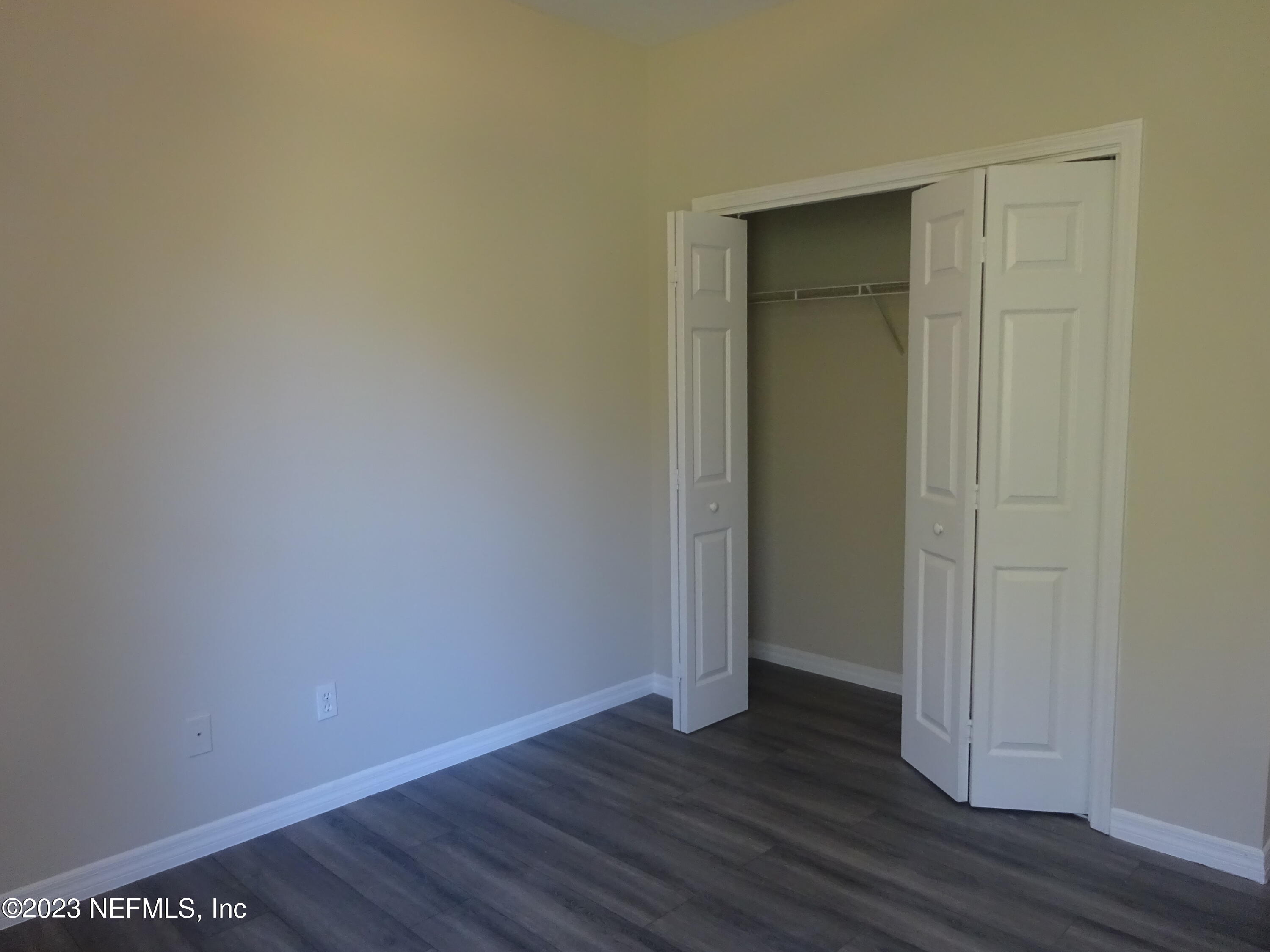 731 East Red House Branch Road St. Augustine, FL 32084 - Photo 29 of 54 a view of an empty room with wooden floor and closet