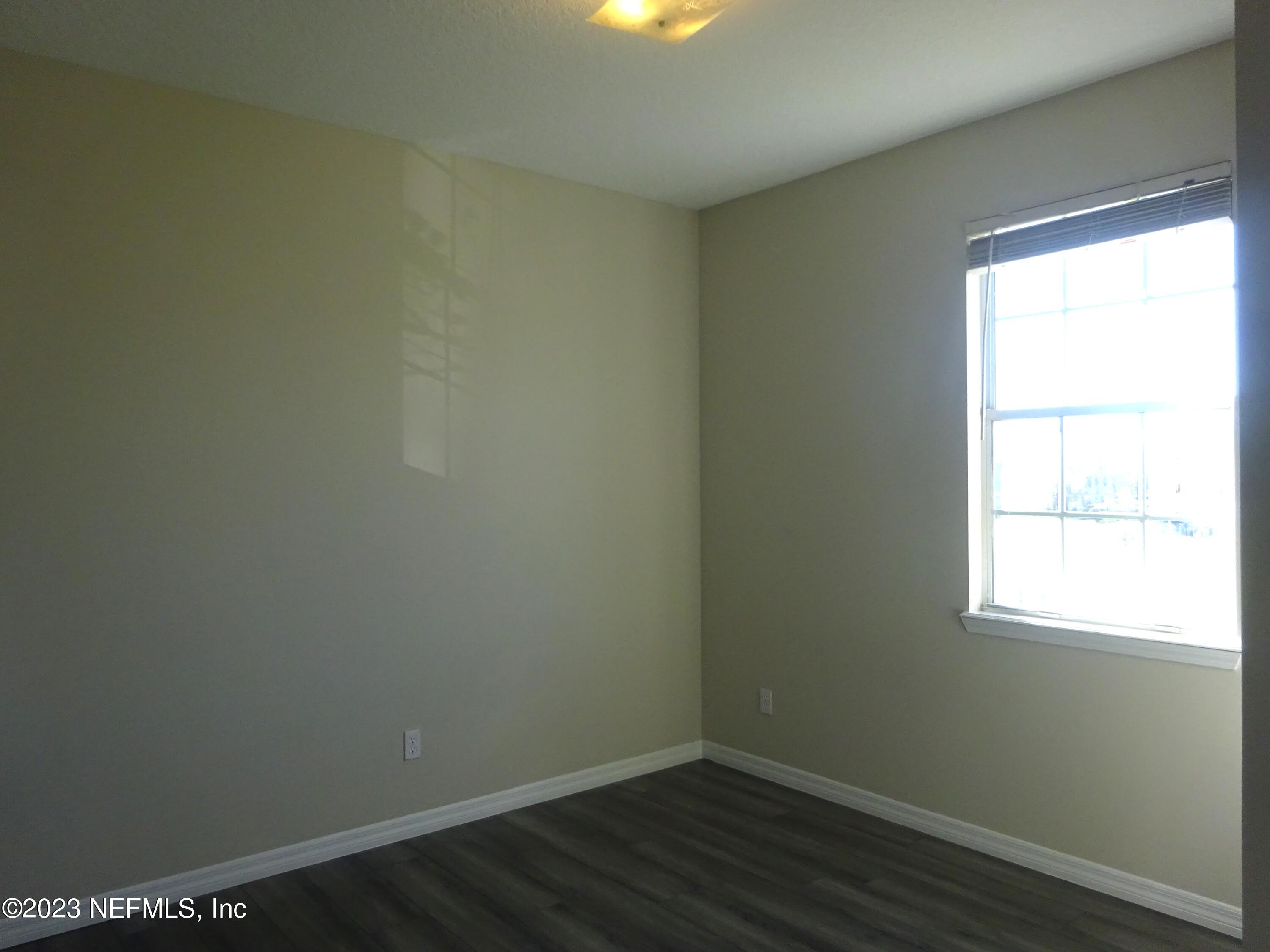731 East Red House Branch Road St. Augustine, FL 32084 - Photo 32 of 54 an empty room with wooden floor and windows