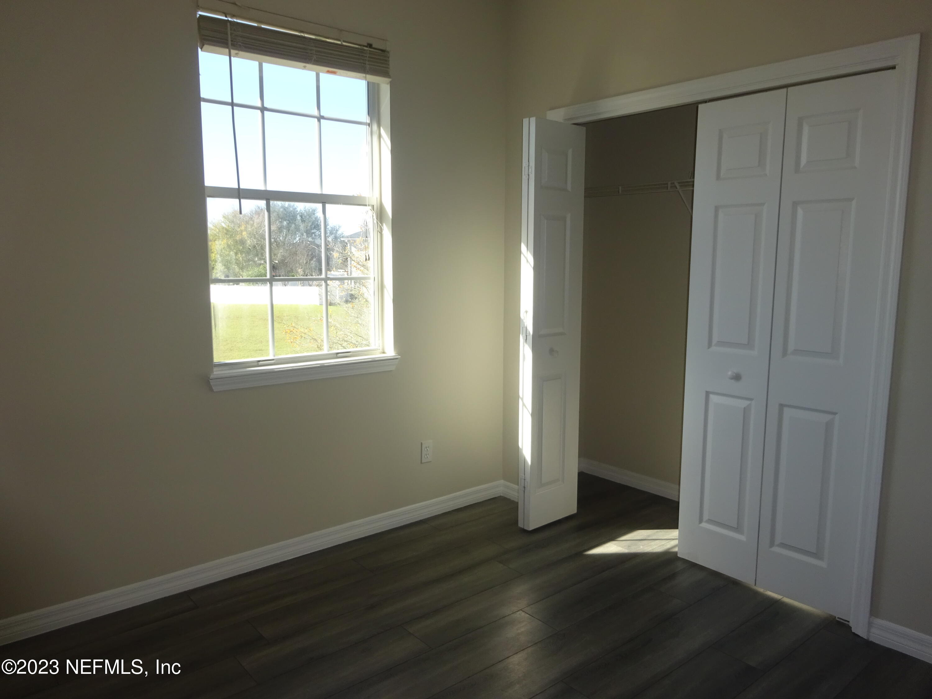 731 East Red House Branch Road St. Augustine, FL 32084 - Photo 33 of 54 an empty room with wooden floor and windows
