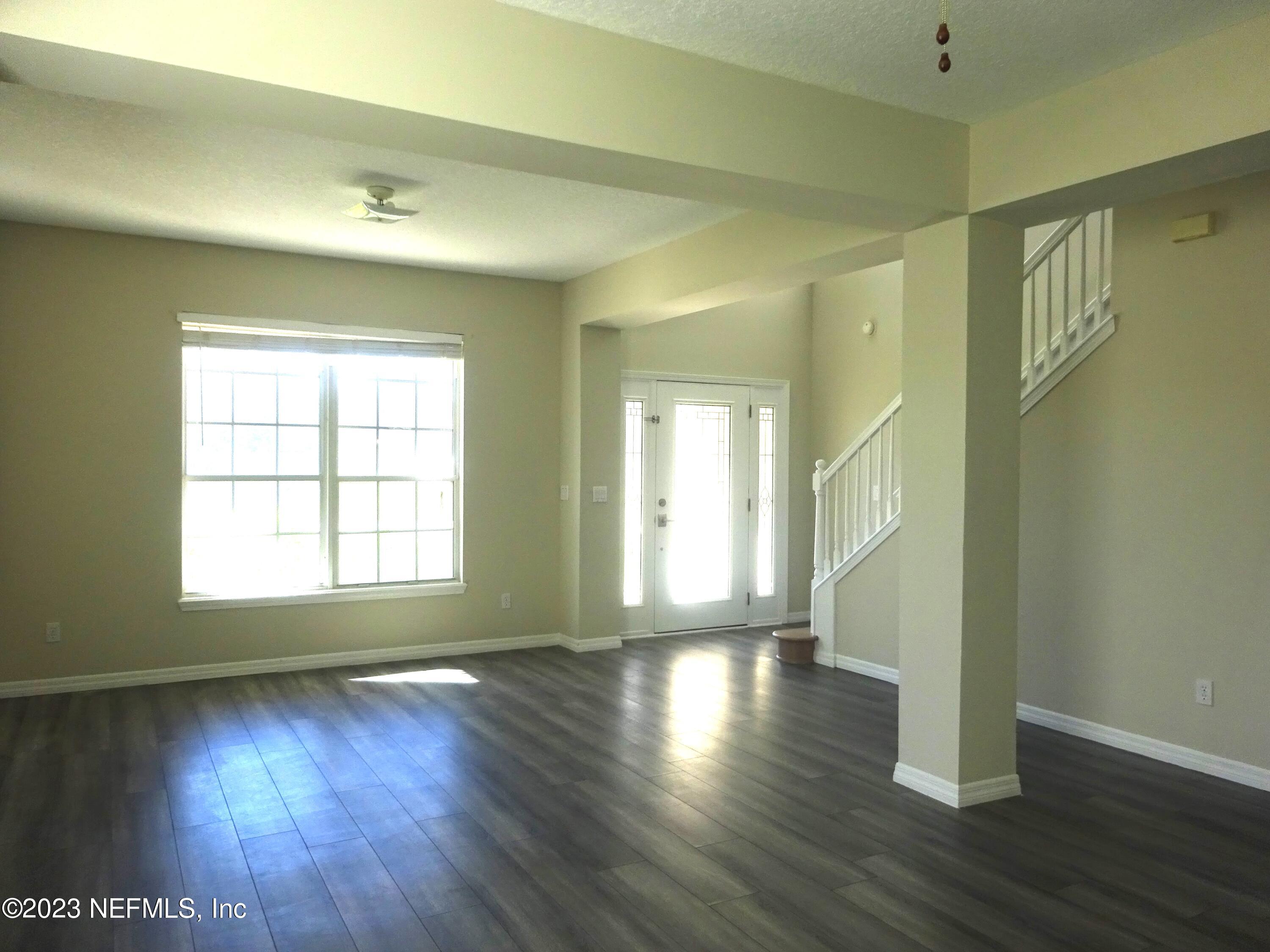 731 East Red House Branch Road St. Augustine, FL 32084 - Photo 5 of 54 a view of an empty room with wooden floor and a window