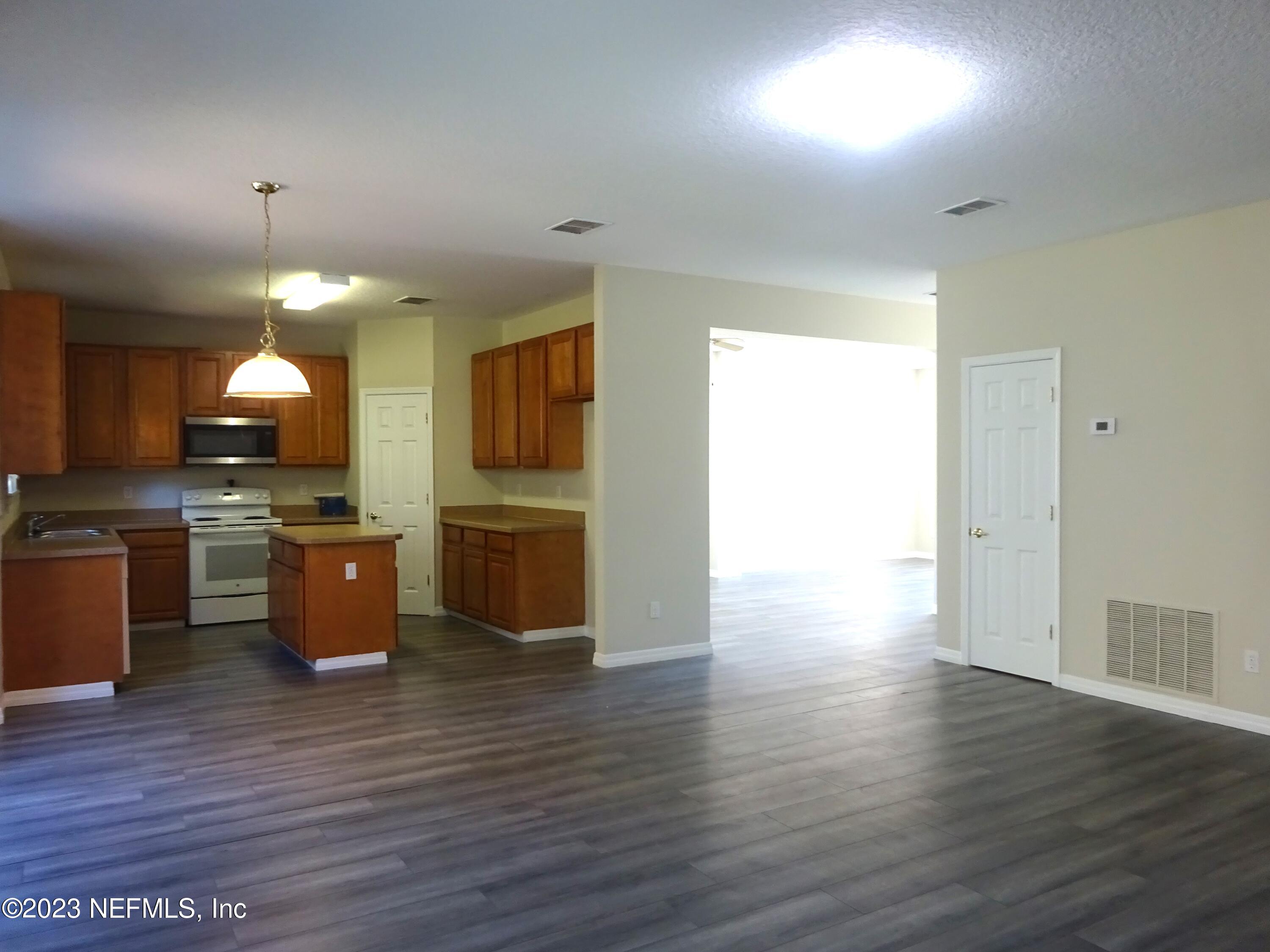 731 East Red House Branch Road St. Augustine, FL 32084 - Photo 8 of 54 a large kitchen with hardwood floor and a sink