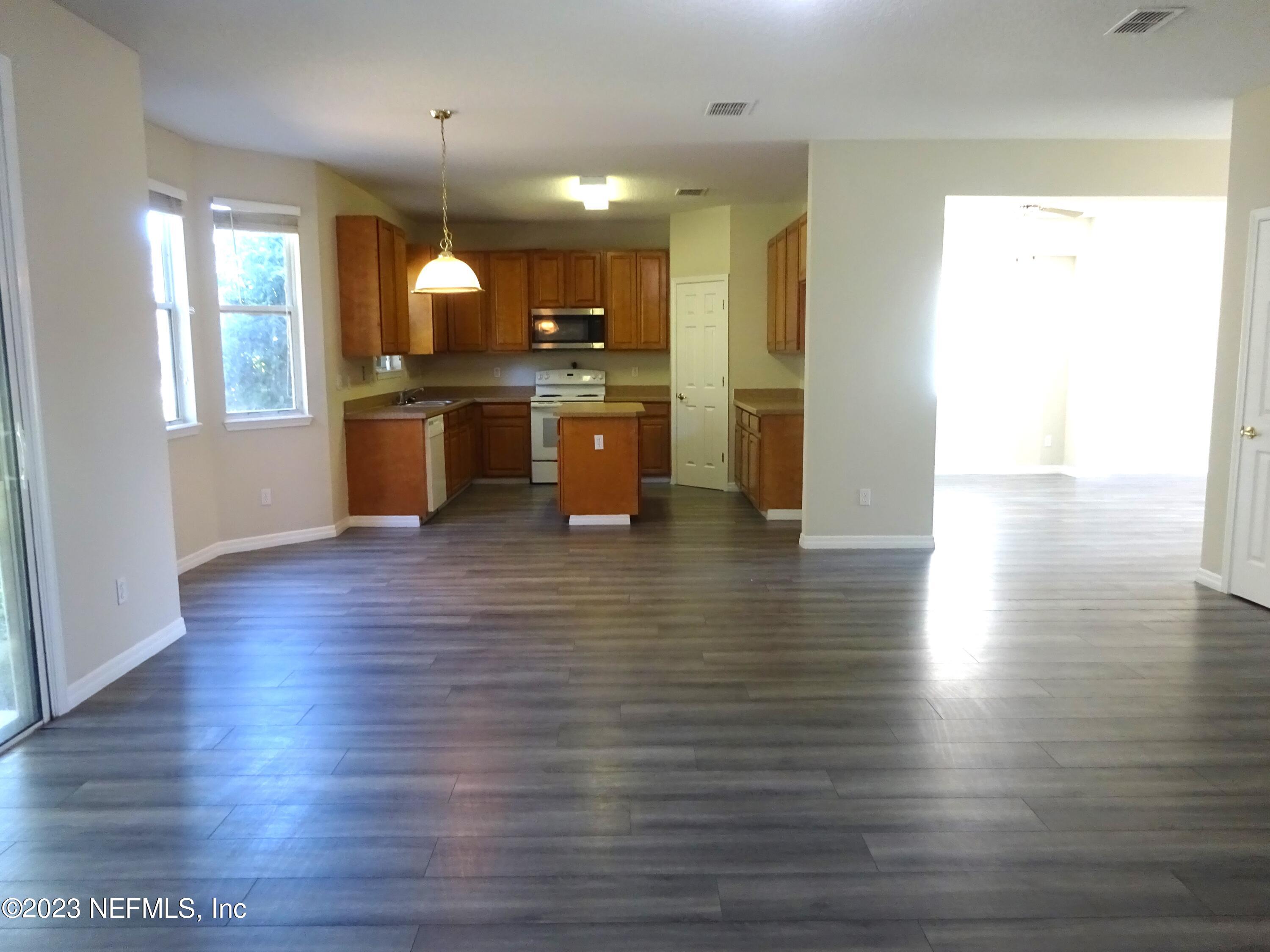 731 East Red House Branch Road St. Augustine, FL 32084 - Photo 9 of 54 a kitchen with stainless steel appliances wooden floor and large window