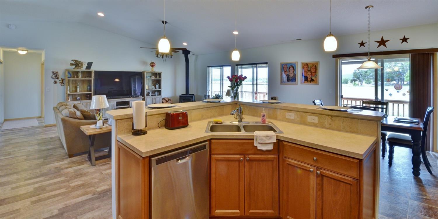 14731 Avalon Road White City, OR 97503 - Photo 14 of 34 a kitchen with a stove and a view of living room