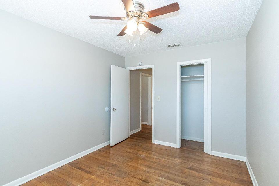 4212 42nd Street Lubbock, TX 79413 - Photo 14 of 18 a view of an empty room with window and wooden floor