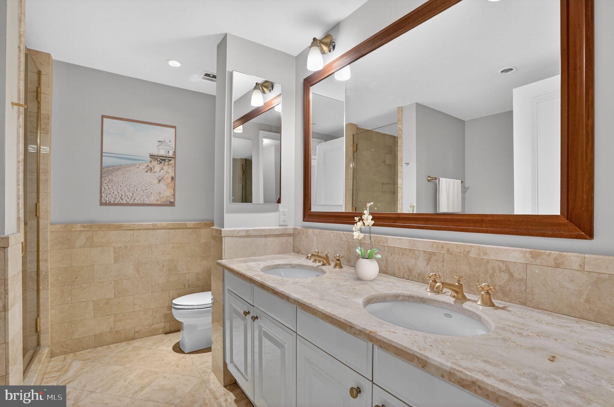 1111 23rd Street Northwest, Unit 2B Washington, DC 20037 - Photo 11 of 22 a bathroom with a granite countertop sink mirror and toilet