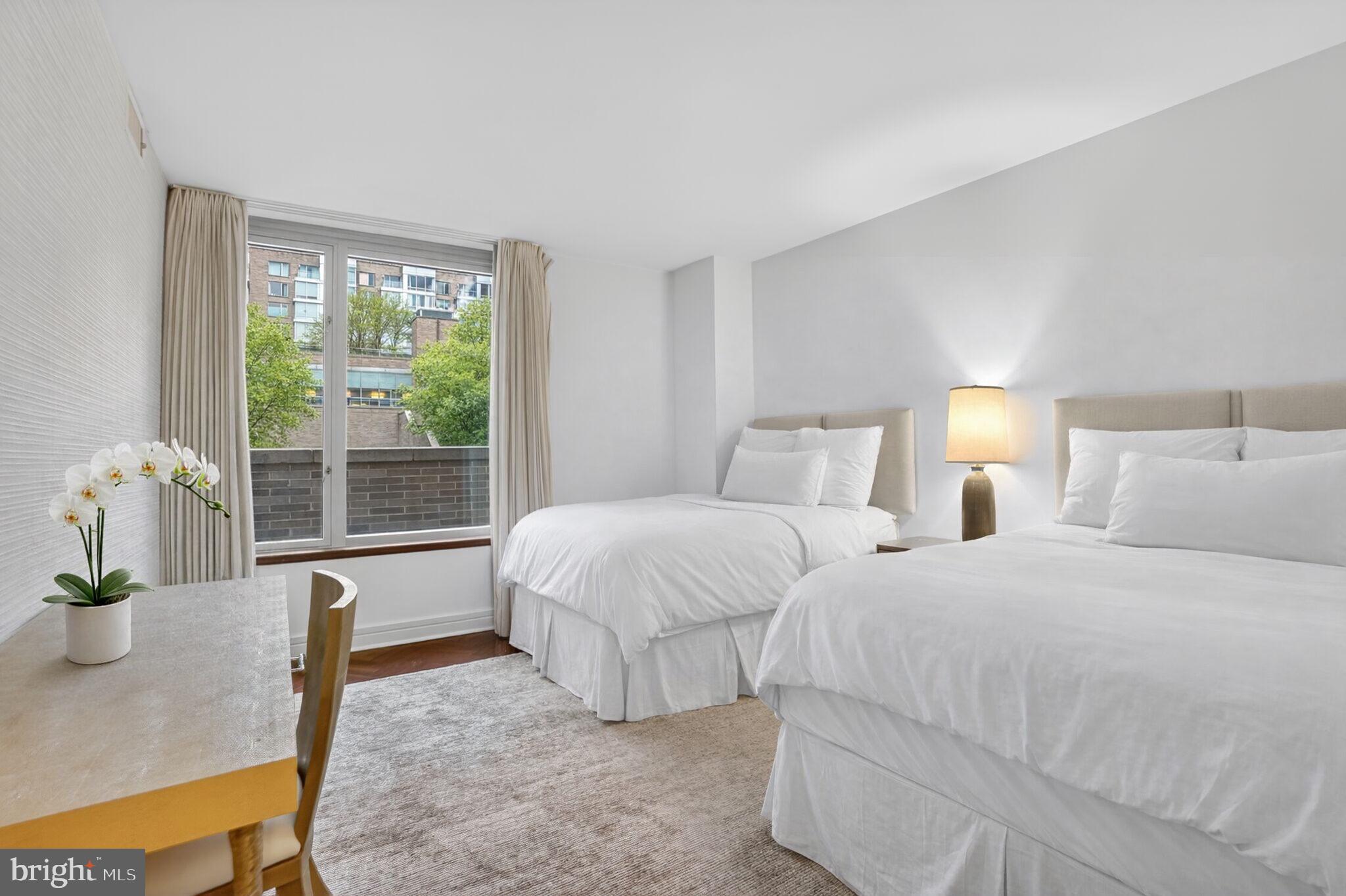 1111 23rd Street Northwest, Unit 2B Washington, DC 20037 - Photo 13 of 22 a spacious bedroom with two beds and with potted plant
