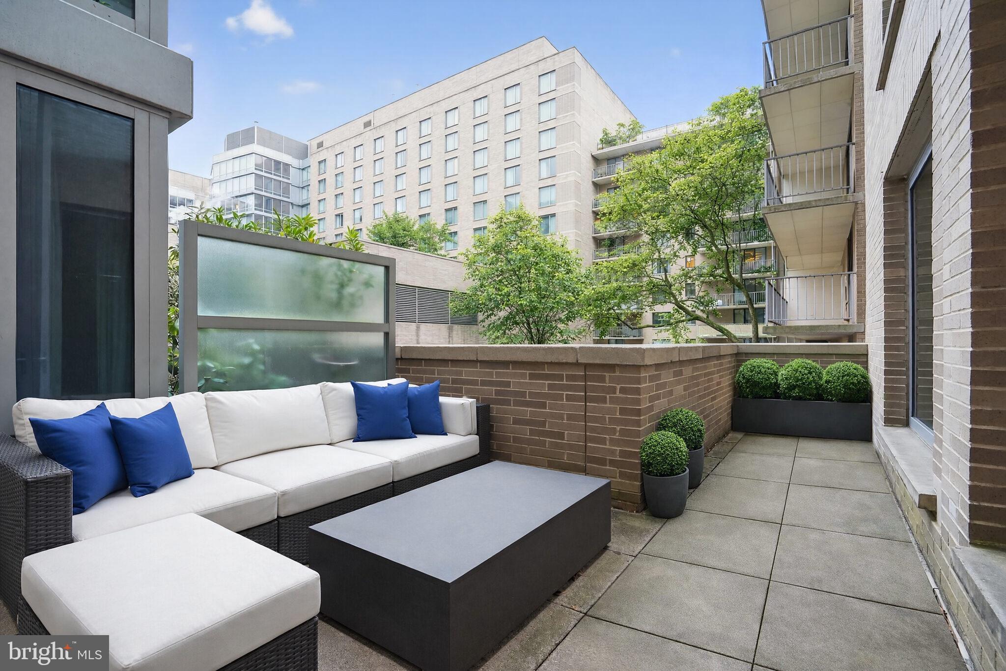 1111 23rd Street Northwest, Unit 2B Washington, DC 20037 - Photo 16 of 22 a view of a patio with couches and a potted plant on a floor