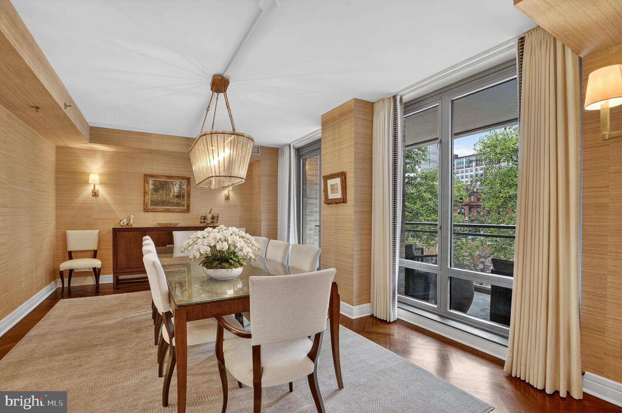 1111 23rd Street Northwest, Unit 2B Washington, DC 20037 - Photo 5 of 22 a dining room with furniture a chandelier and wooden floor