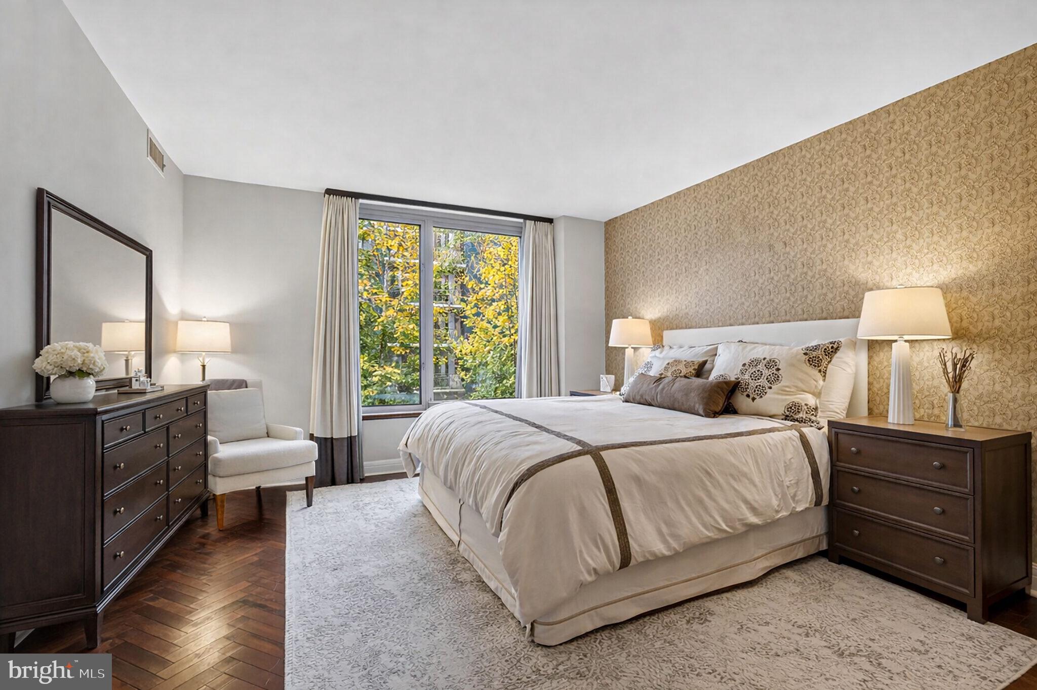 1111 23rd Street Northwest, Unit 2B Washington, DC 20037 - Photo 10 of 22 a bedroom with a bed and wooden floor