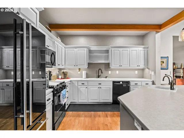 a kitchen with a refrigerator sink and cabinets