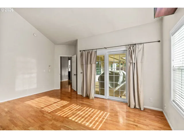 a view of a room with wooden floor and windows