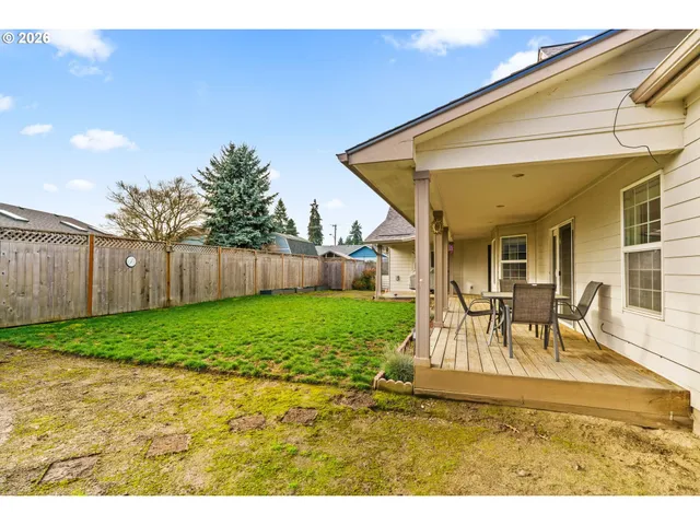 a view of a house with backyard and sitting area