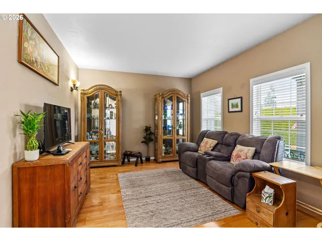 a living room with furniture large window and flat screen tv