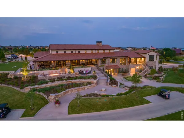 an aerial view of a house with a yard basket ball court and outdoor seating