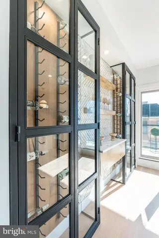 a view of a hallway with closet and a bathroom