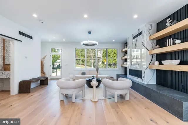 a bathroom with a tub a sink and a large mirror