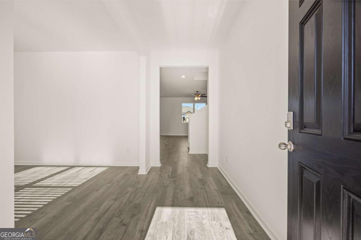 209 Cattle Drive Perry, GA 31069 - Photo 15 of 47 a view of a hallway with wooden floor and staircase
