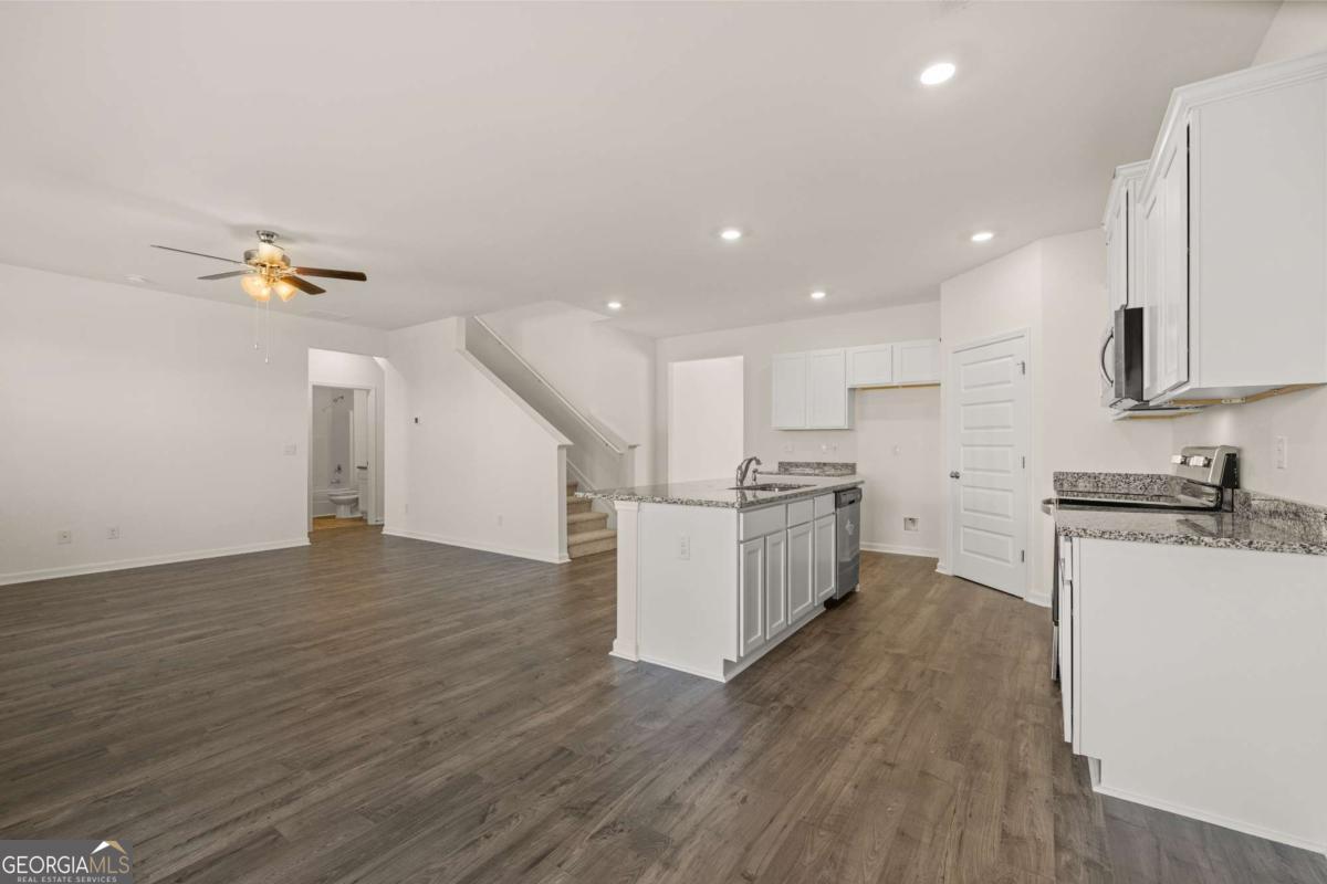 209 Cattle Drive Perry, GA 31069 - Photo 22 of 47 a view of a kitchen with wooden floor and electronic appliances