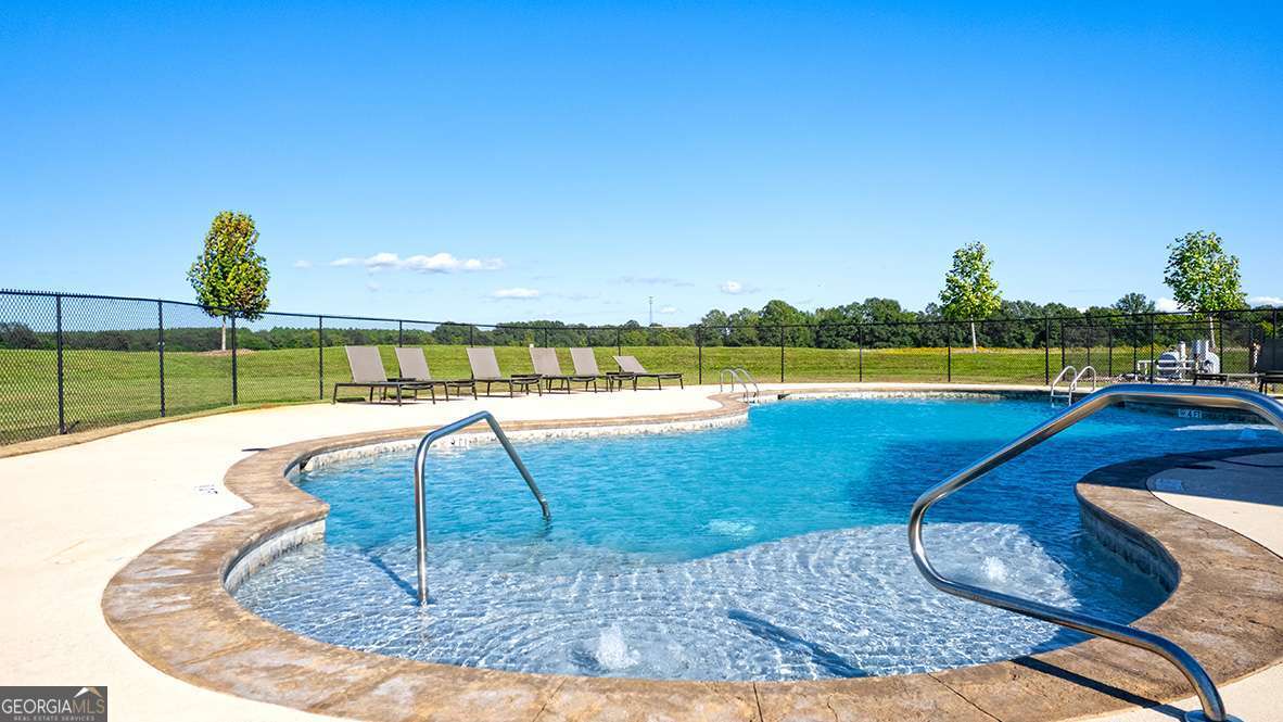 209 Cattle Drive Perry, GA 31069 - Photo 6 of 47 a view of a swimming pool with a lounge chairs