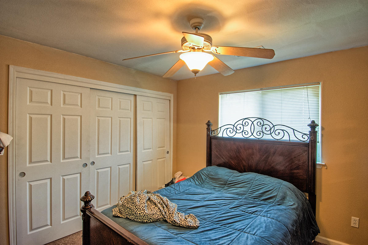 170 Gilmore Road Red Bluff, CA 96080 - Photo 14 of 33 a bedroom with a bed and a chandelier