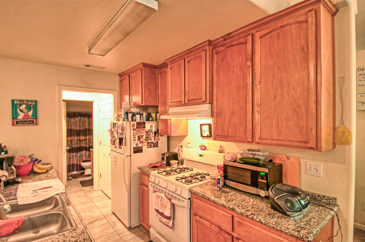170 Gilmore Road Red Bluff, CA 96080 - Photo 22 of 33 a kitchen with a stove a refrigerator and cabinets