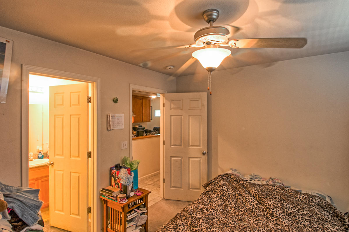 170 Gilmore Road Red Bluff, CA 96080 - Photo 24 of 33 a bedroom with a bed and a chandelier