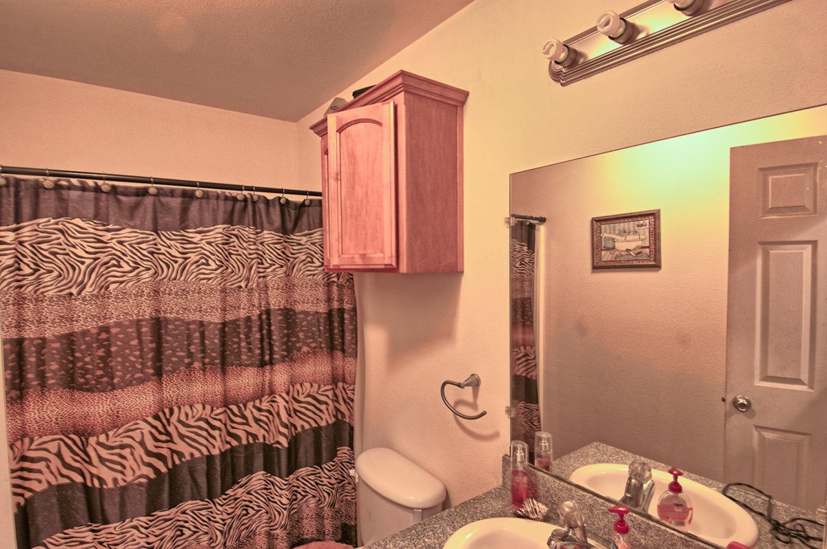 170 Gilmore Road Red Bluff, CA 96080 - Photo 26 of 33 a bathroom with a sink mirror vanity and toilet