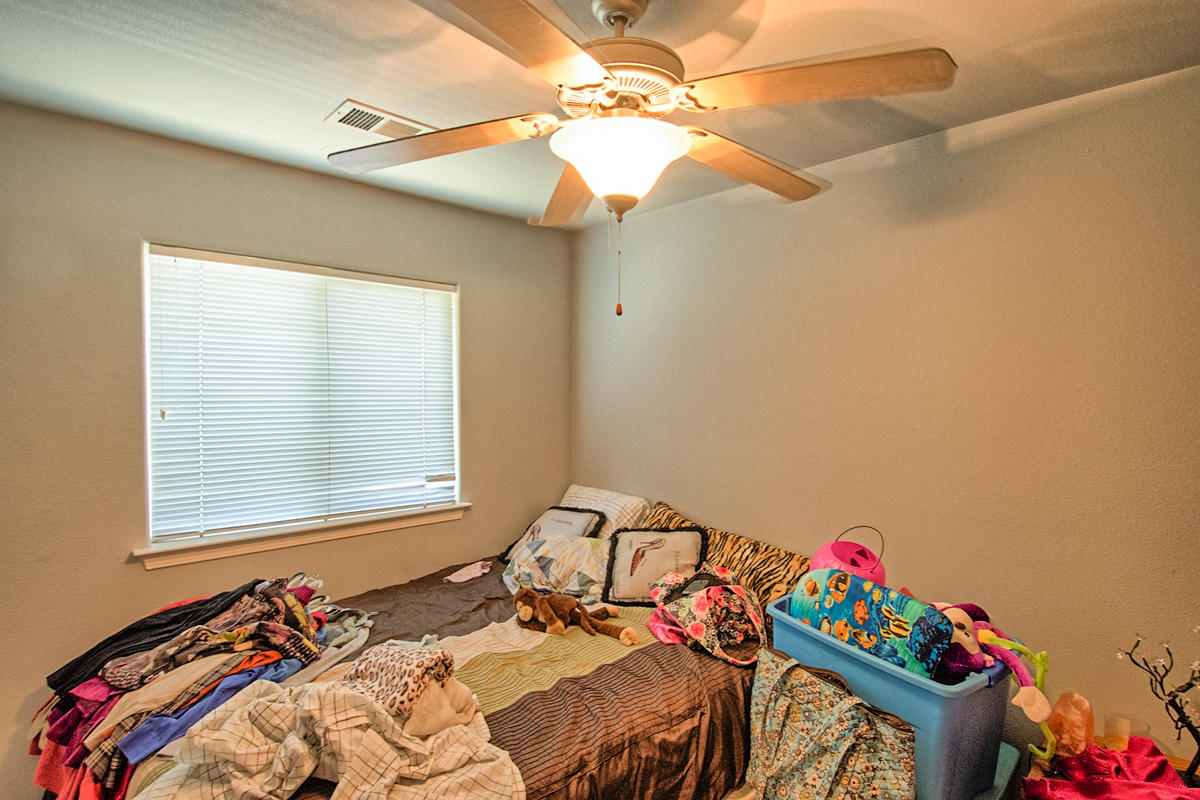 170 Gilmore Road Red Bluff, CA 96080 - Photo 30 of 33 a bedroom with a bed and a chandelier