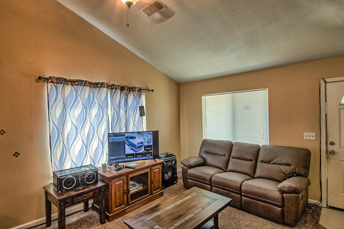 170 Gilmore Road Red Bluff, CA 96080 - Photo 5 of 33 a living room with furniture a flat screen tv and a window