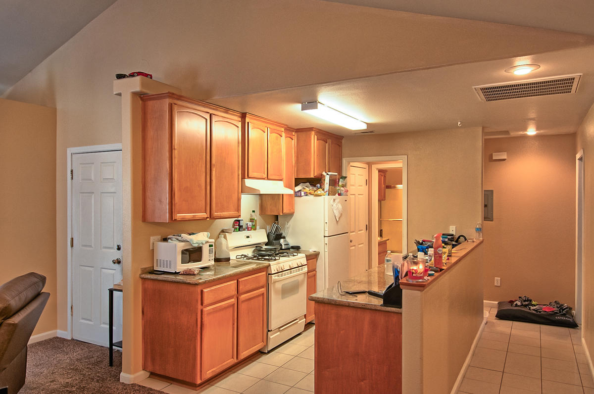 170 Gilmore Road Red Bluff, CA 96080 - Photo 9 of 33 a kitchen with sink a refrigerator and cabinets