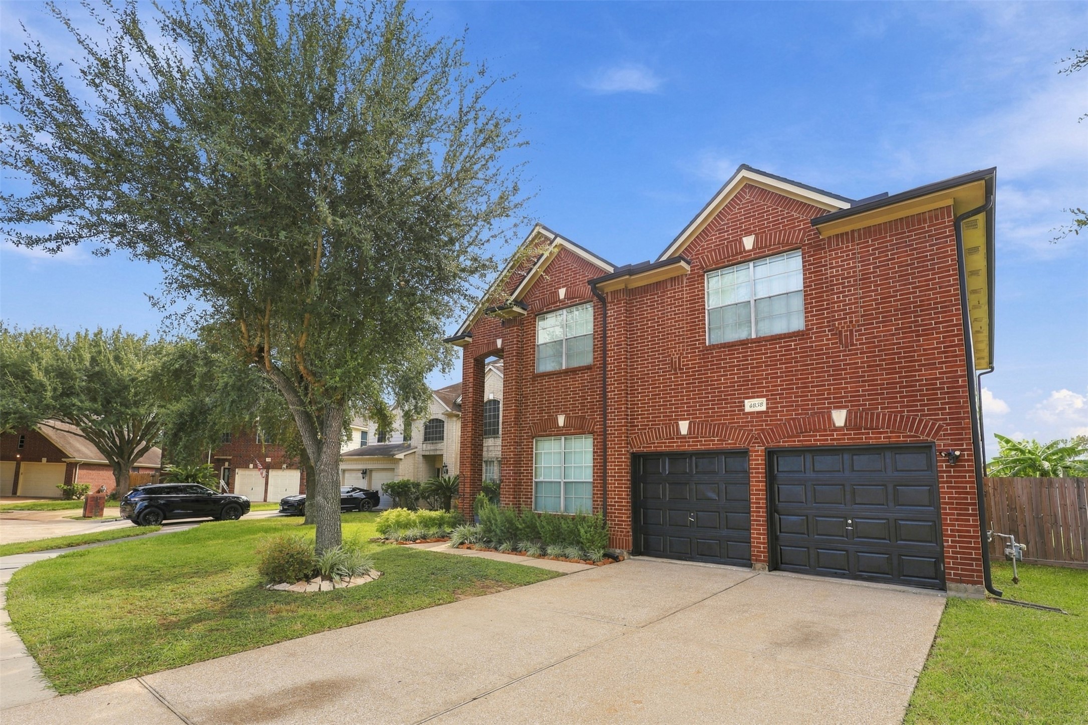 4838 Roaring Springs Road Pasadena, TX 77505 - Photo 3 of 38 Stunning two-story brick home with charming curb appeal, featuring a spacious driveway, lush landscaping, and a welcoming front facade.
