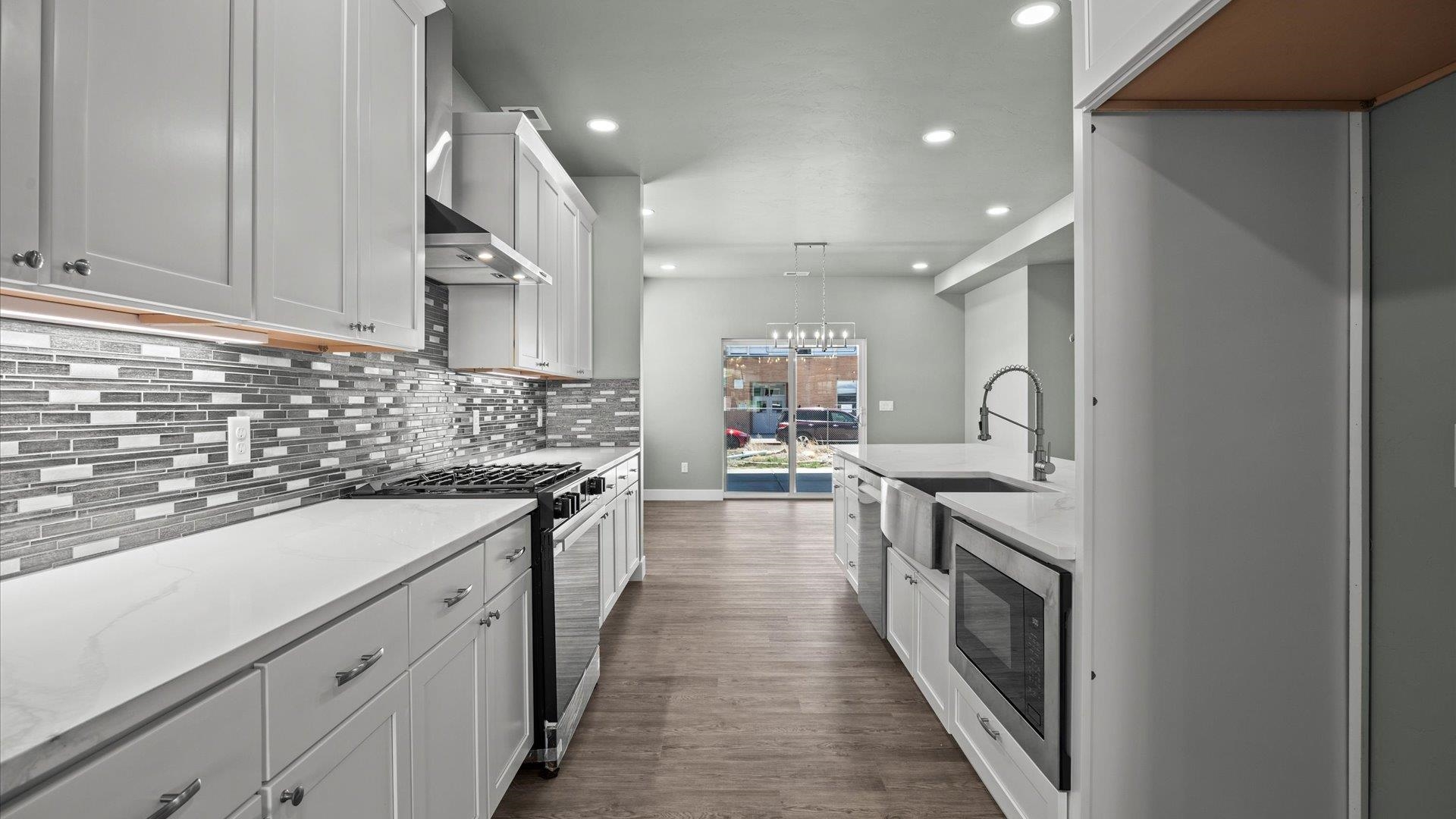 579 Fledgefield Drive Grand Junction, CO 81504 - Photo 13 of 30 a kitchen with a sink stove and cabinets