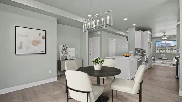 an empty room with a chandelier fan and windows