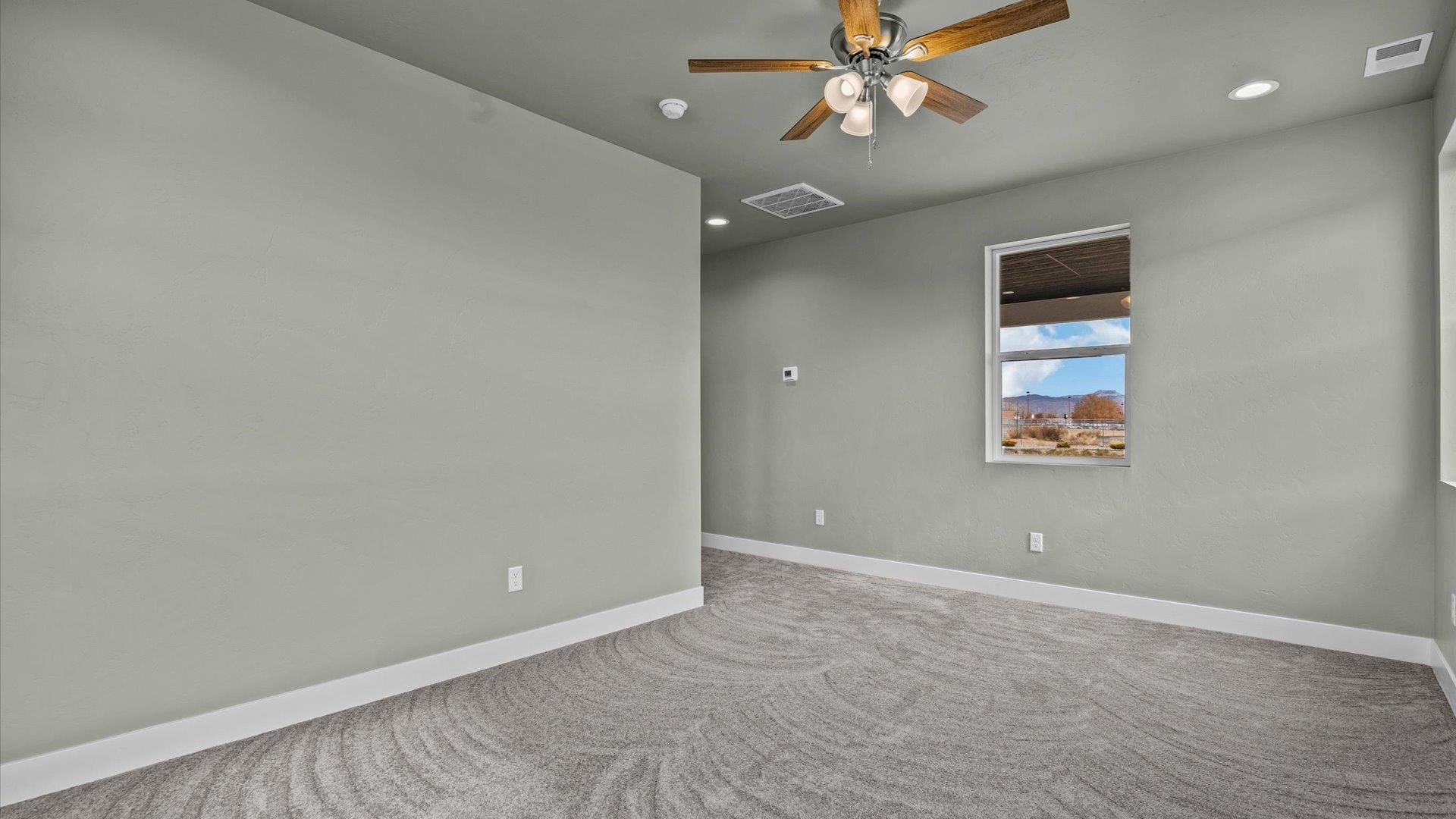 579 Fledgefield Drive Grand Junction, CO 81504 - Photo 17 of 30 an empty room with a fan & a window