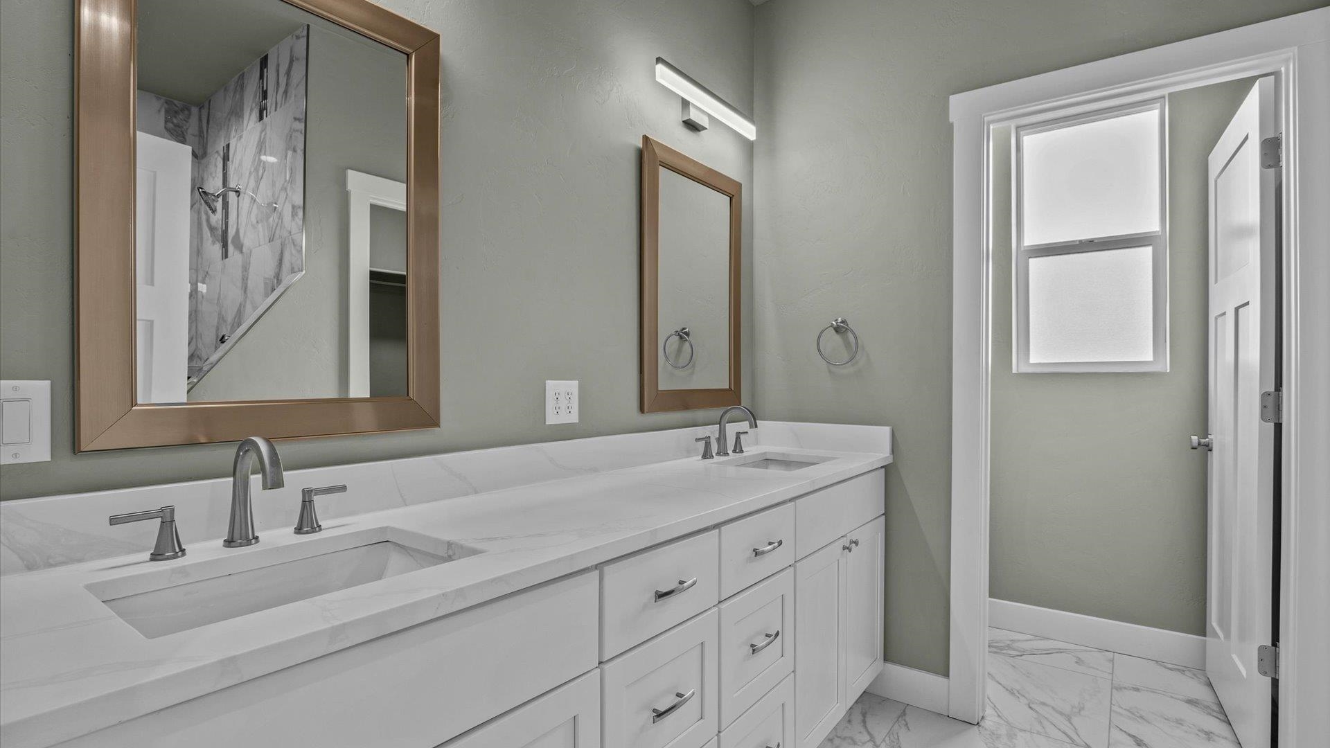 579 Fledgefield Drive Grand Junction, CO 81504 - Photo 18 of 30 a bathroom with a granite countertop sink double and mirror