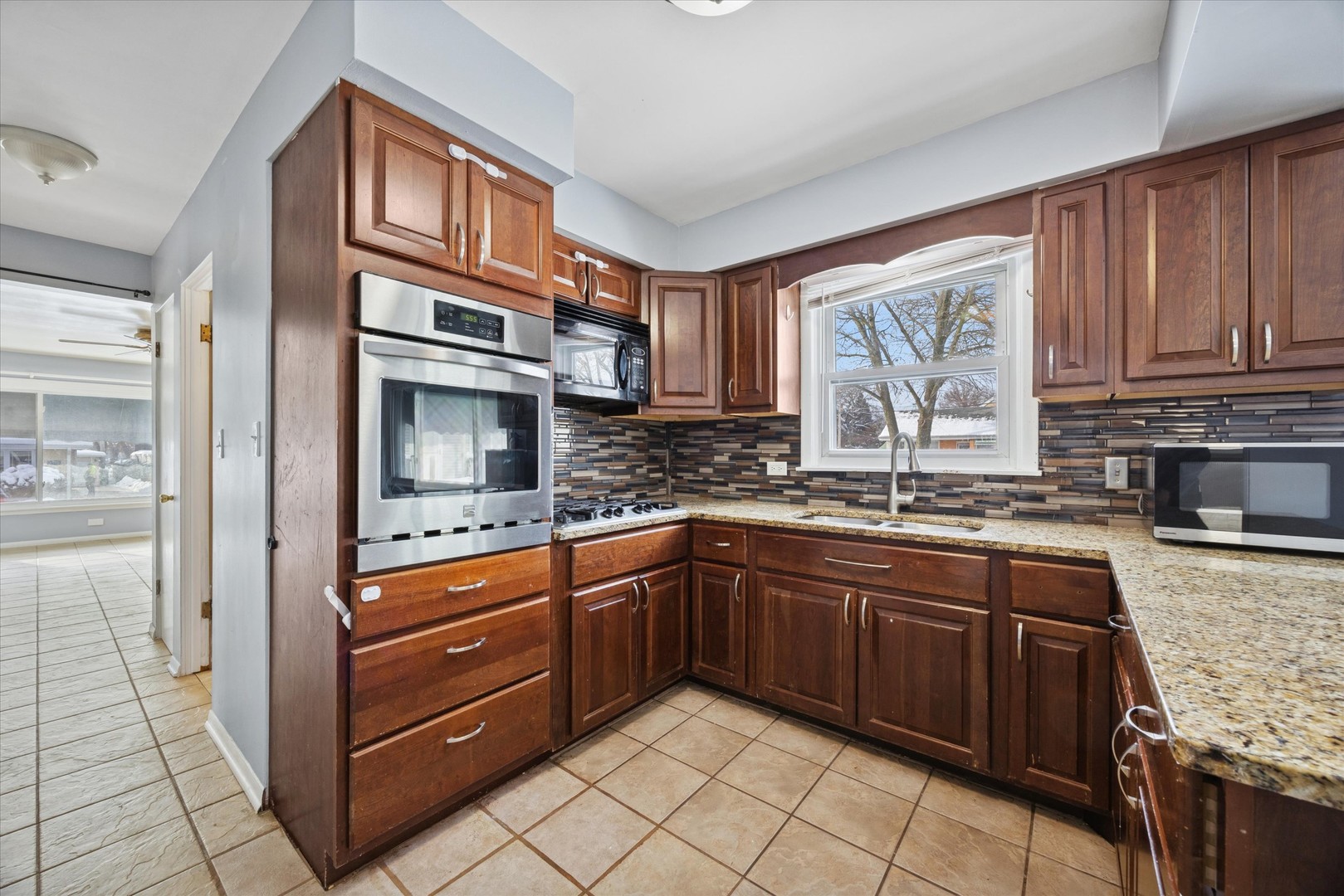 6718 41st Street Stickney, IL 60402 - Photo 11 of 15 a kitchen with stainless steel appliances granite countertop a sink stove and cabinets